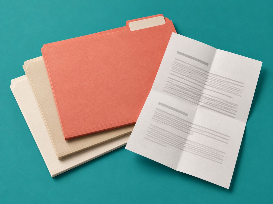 Coral, sand and cream file folders beside a folded single-page licence sheet